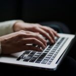 Person typing on laptop